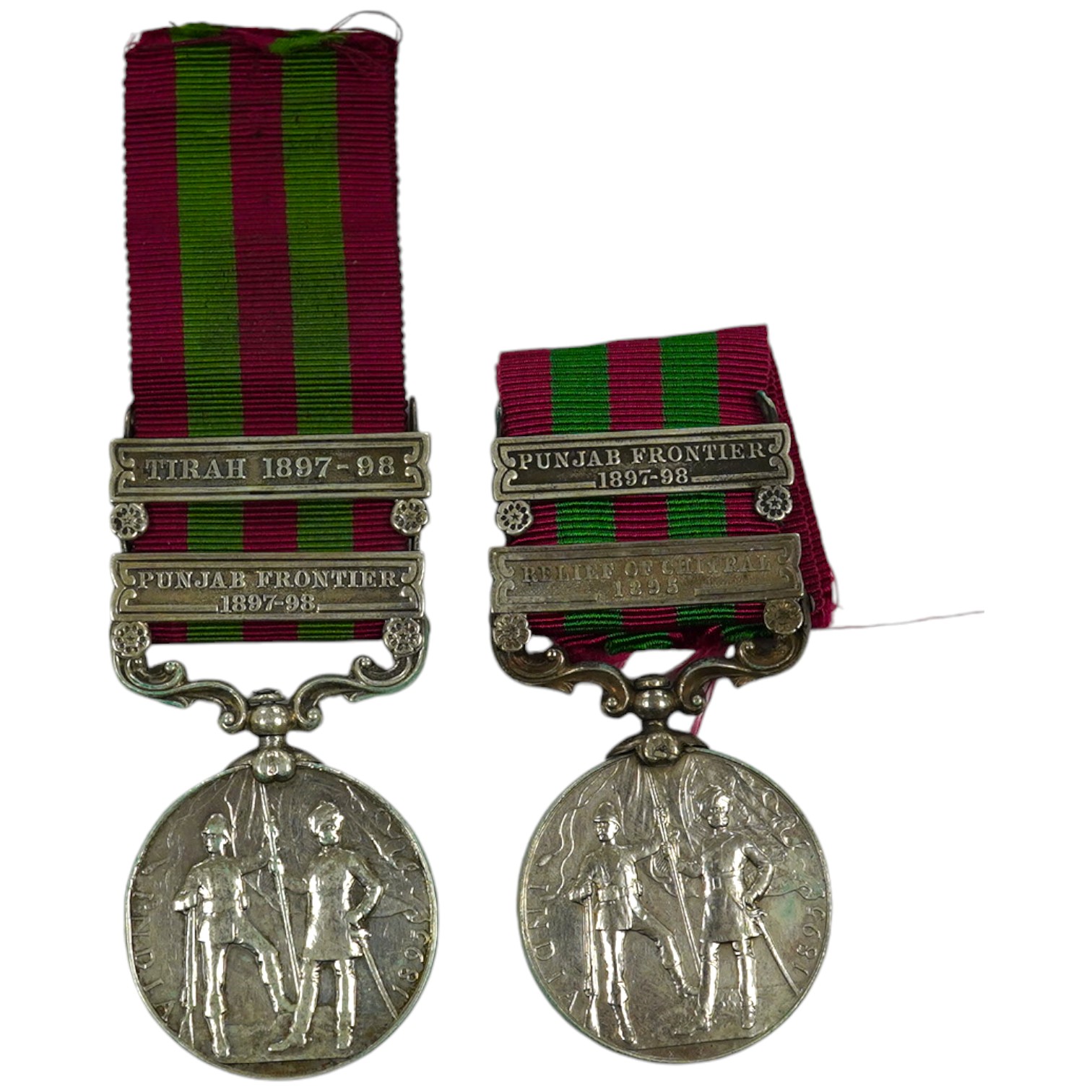 Two India Medals; one with Punjab Frontier 1897-98 and Relief of Chitral 1895 clasps, the other Tirah 1897-98 and Punjab Frontier 1897-98, both with naming erased.